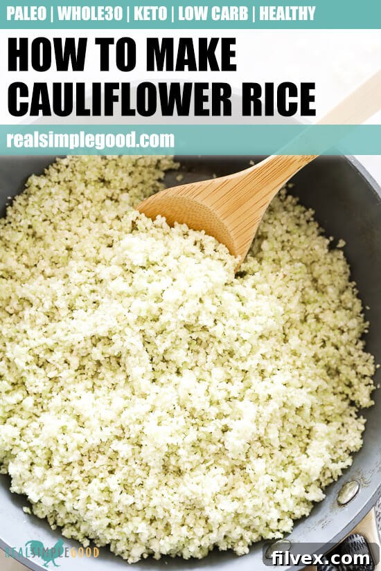 Vertical overhead close-up image of cauliflower rice in a skillet with a serving spoon, ready to be enjoyed.
