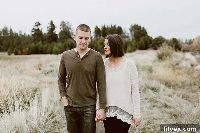 A couple, Justin and Erica Winn, walking outside and facing the camera with a sense of hopeful adventure.