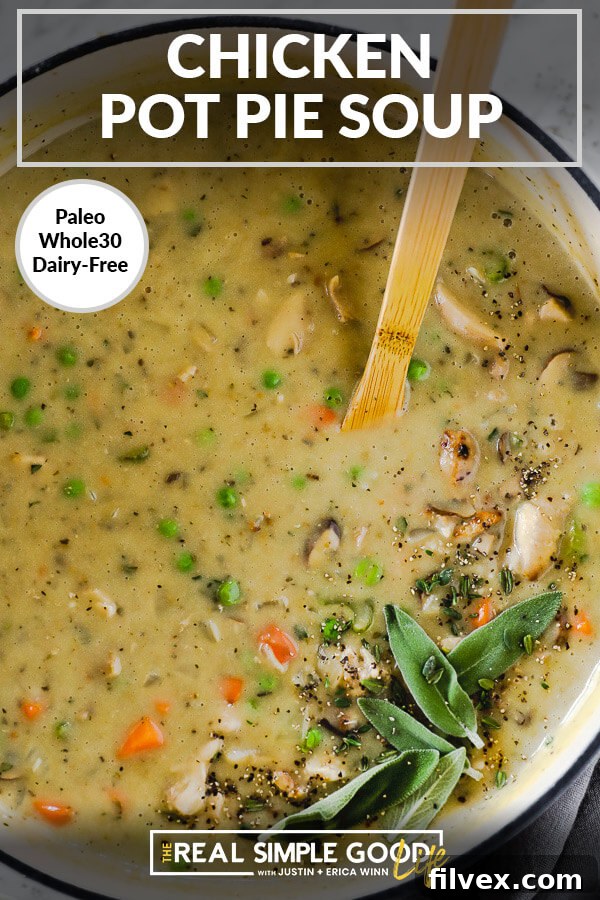Close up vertical image of chicken pot pie soup in a large soup pot with a wooden spoon. Garnished with fresh sage, thyme and ground pepper. Text overlay at top. 