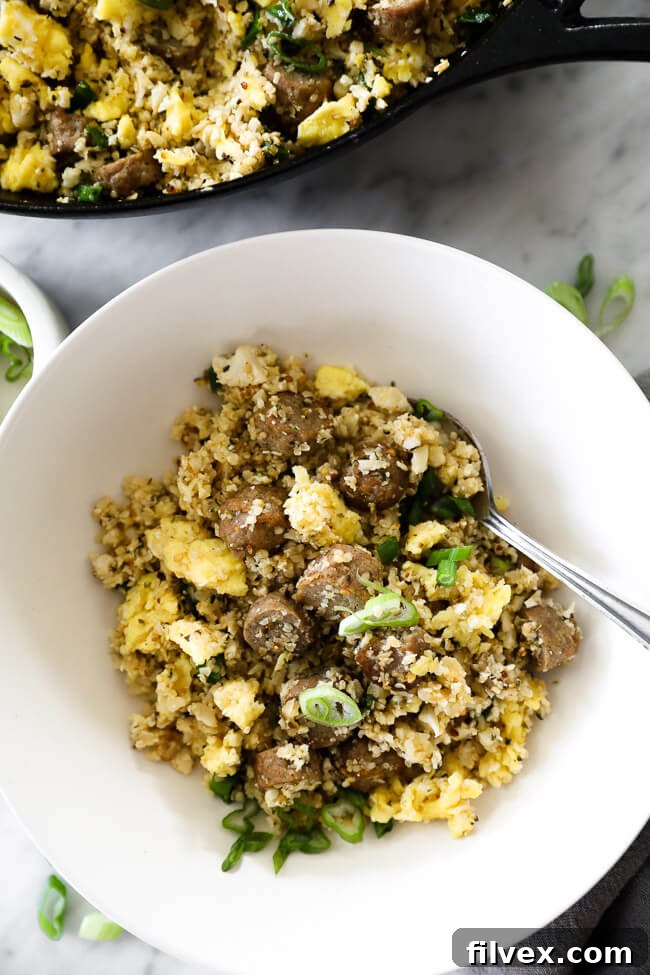 Close up of fried rice served in a bowl with a fork, ready to be enjoyed.