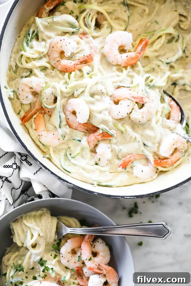 Close up image vertical overhead image of creamy garlic shrimp in skillet with some also served in a bowl. 