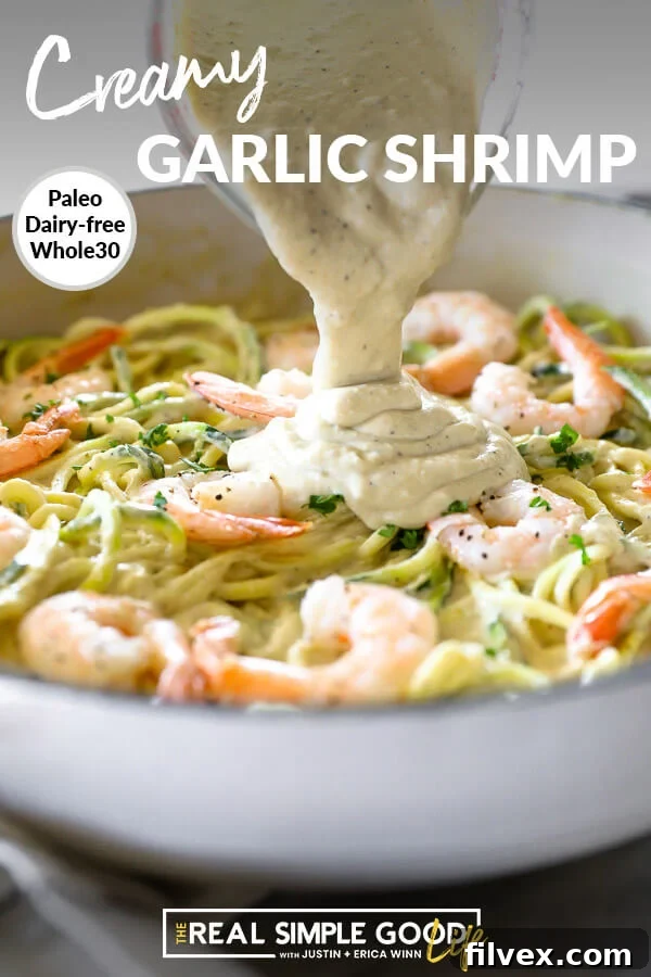 Creamy garlic shrimp in paw with sauce pouring on top. Text at top.