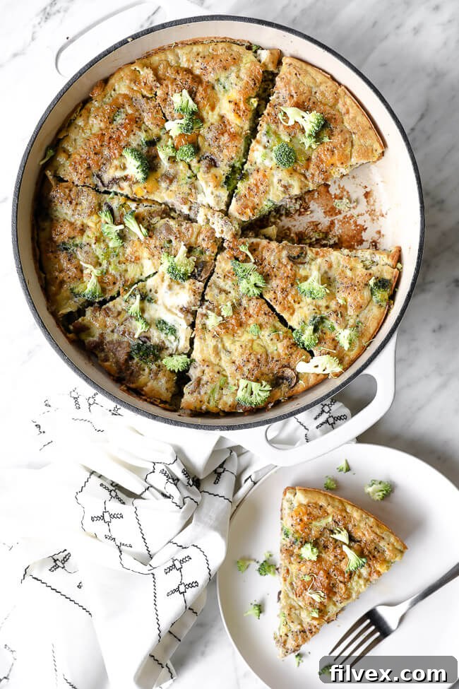 Vertical overhead image of Keto frittata in a skillet with one piece removed and served up on a plate with a fork.