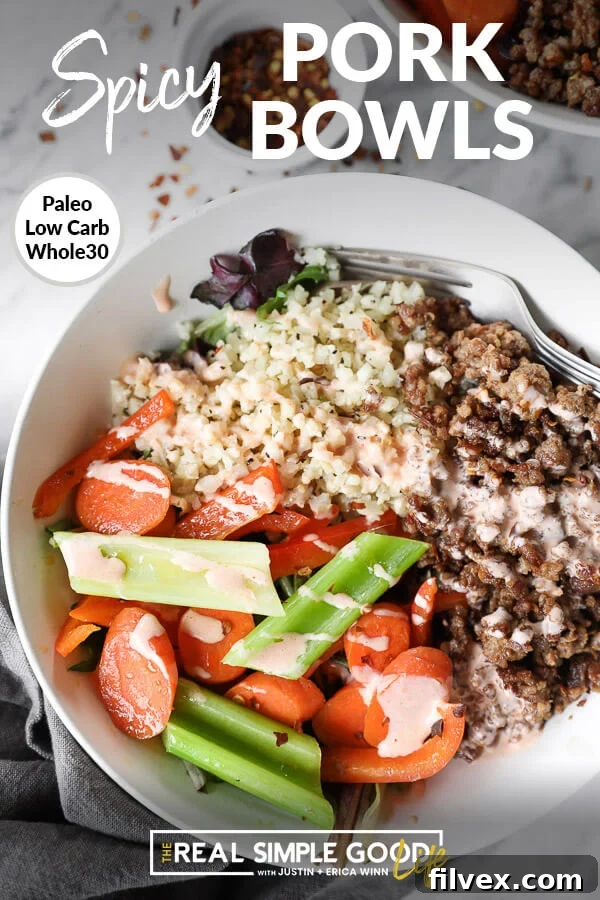 Vertical close up image of bowl of cauliflower rice, spicy pork and veggies with text overlay at top that says "Spicy Pork Bowls - Paleo, Whole30, Low Carb", highlighting the dish features.