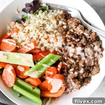Spicy ground pork bowls with veggies and sauce over the top