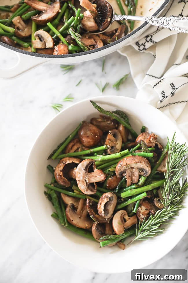 Close-up of freshly sautéed mushrooms and asparagus in a pan