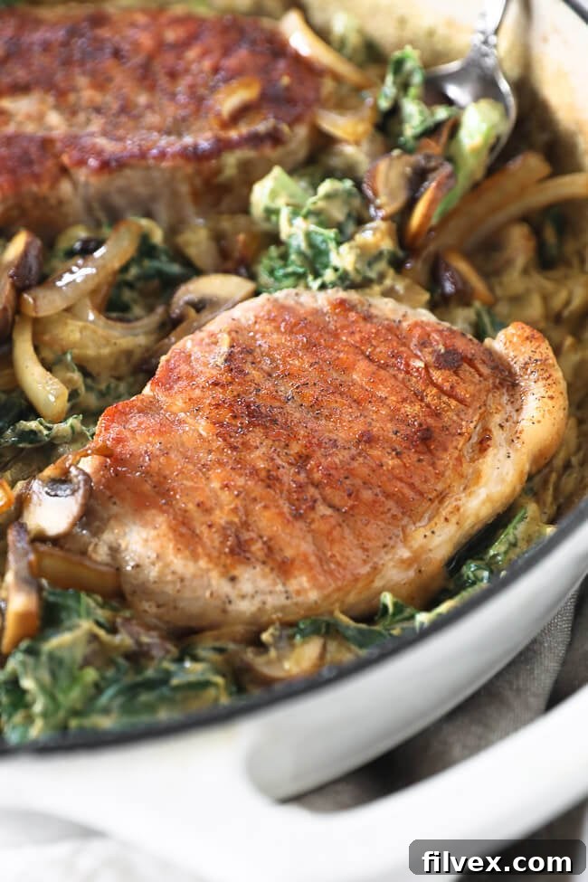 Vertical angled close up image of one pork chop in the skillet.