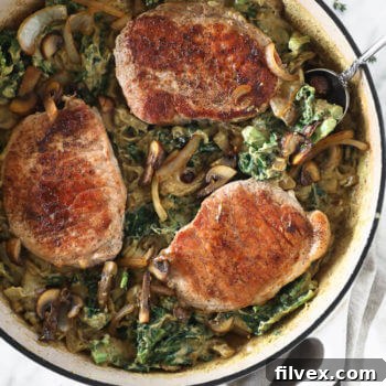 Creamy pork chops in a skillet.