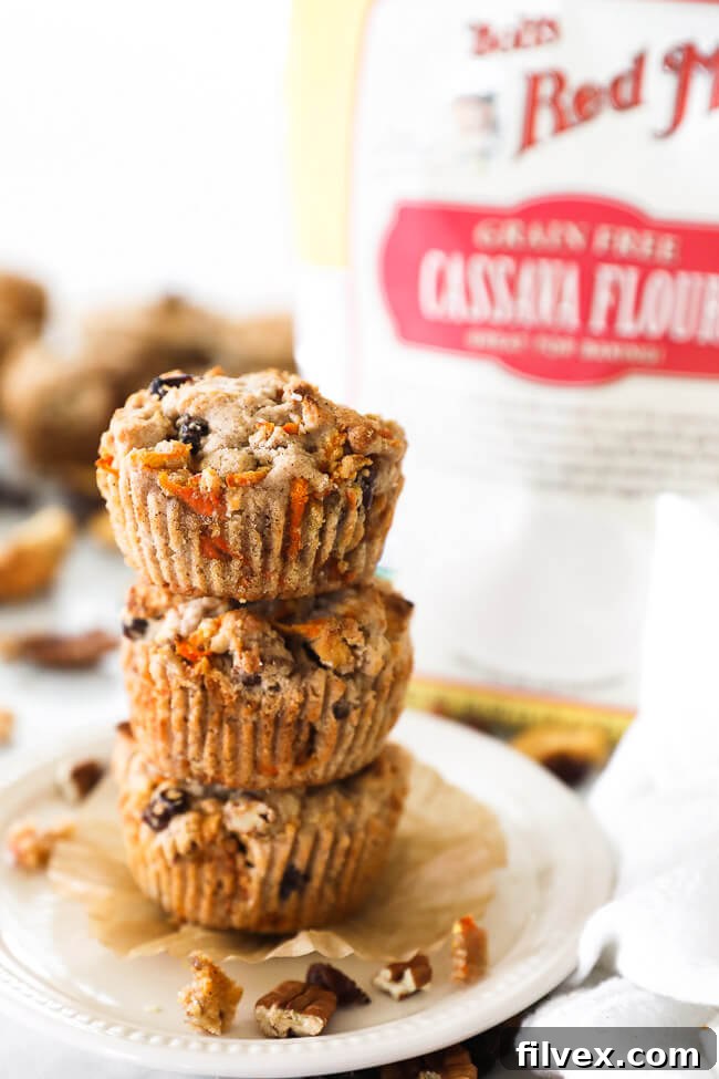 Vertical straight on image of a stack of three breakfast muffins. Delicious and healthy Morning Glory Muffins.