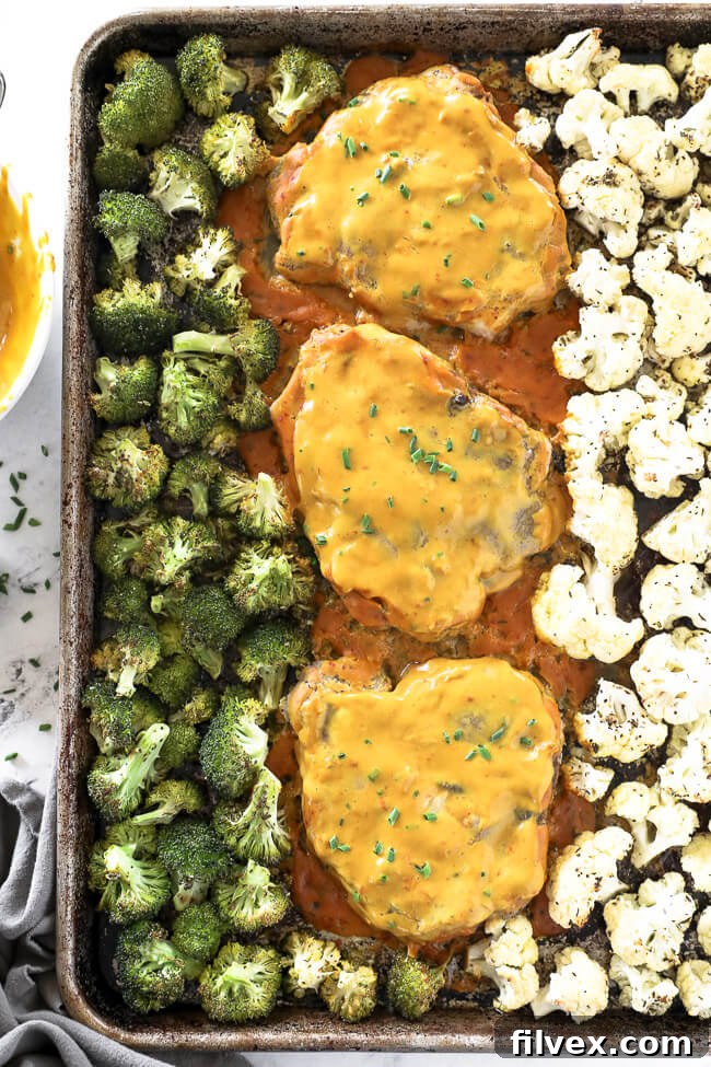 Honey mustard pork chops on a sheet pan with broccoli and cauliflower. 