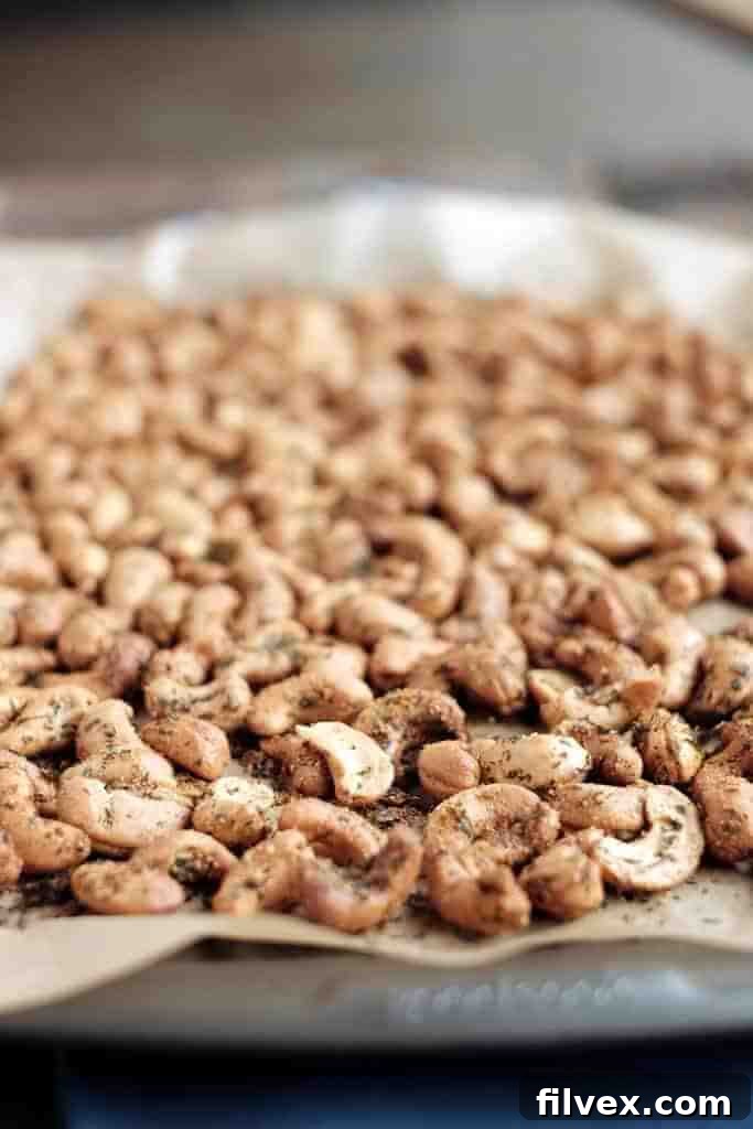 Crispy, savory ranch roasted cashews piled high in a rustic bowl, ready for snacking. Perfect for parties, paleo-friendly, and incredibly easy to make. | realsimplegood.com