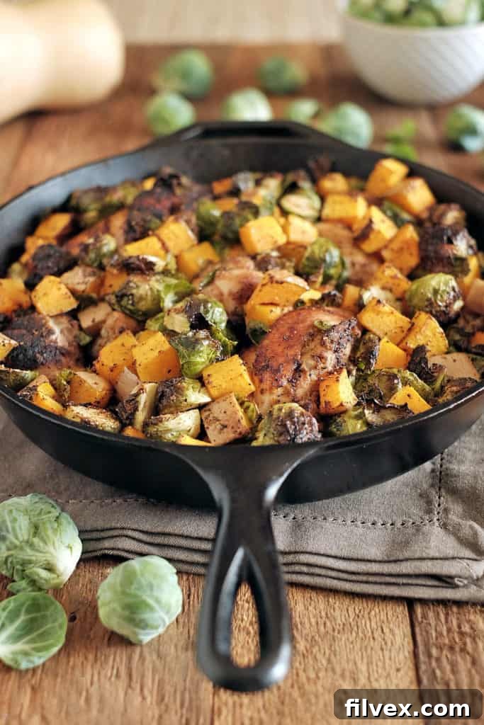 Seasoned bone-in chicken and fresh vegetables in a cast iron skillet