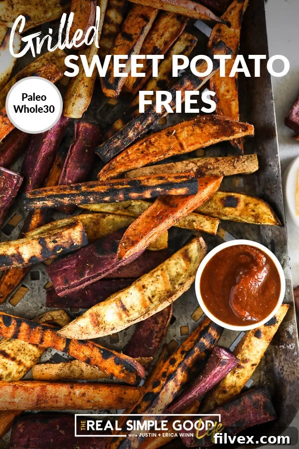 Overhead view of grilled sweet potato fries perfectly arranged on a grilling pan, with a dollop of ketchup on the pan's edge, creating an appetizing scene.