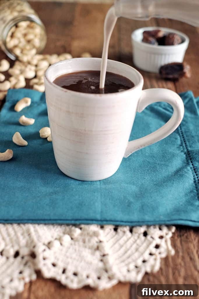 Pouring Dairy-Free Coffee Creamer into a Freshly Brewed Coffee Cup