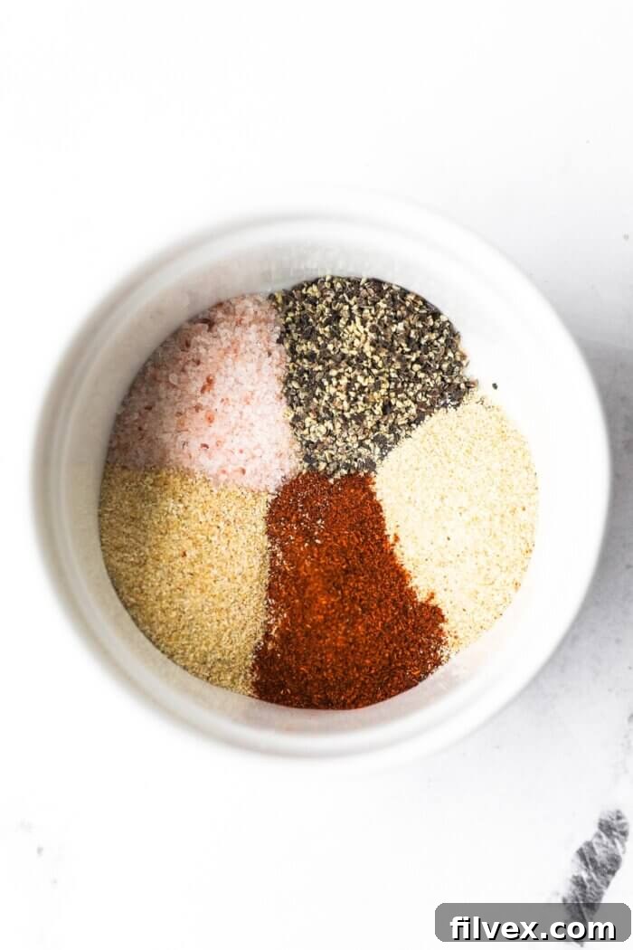 Close-up of a bowl with mixed seasoning for chicken drumsticks.