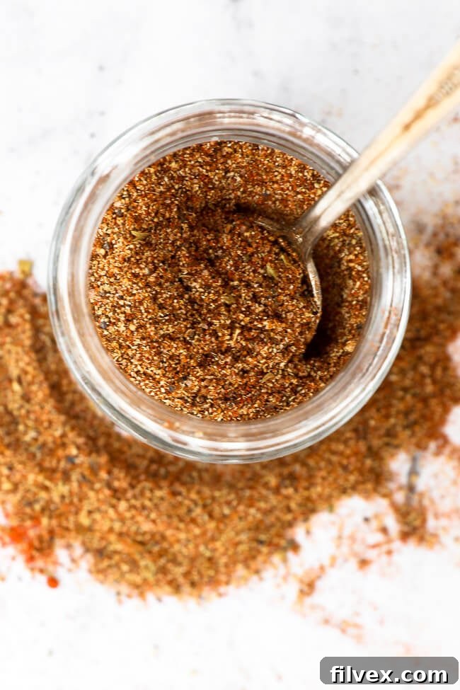 Keto taco seasoning in a jar with a spoon close up overhead image