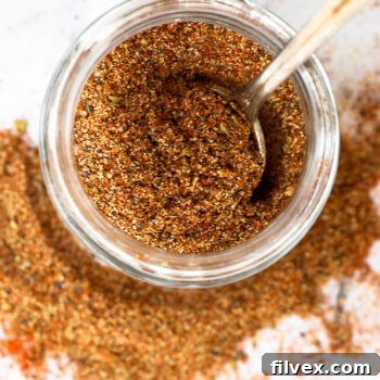 Overhead shot of keto taco seasoning in a jar with spoon coming out