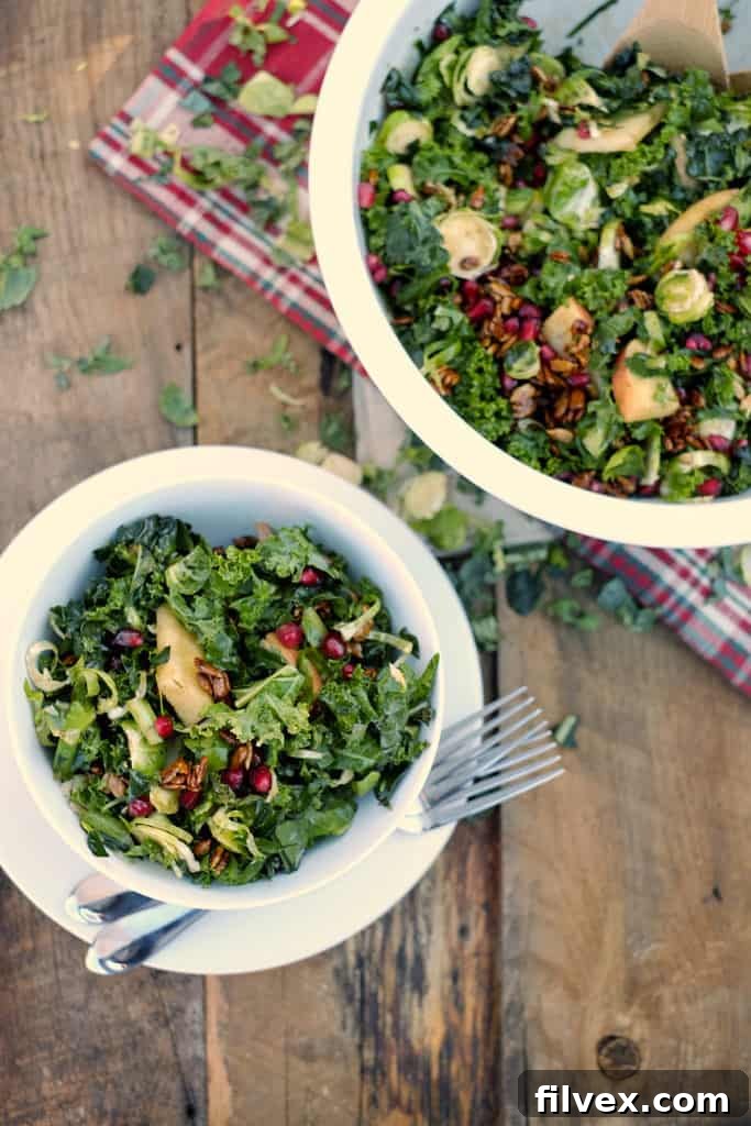 Close-up of winter salad showcasing vibrant kale and pomegranate seeds.