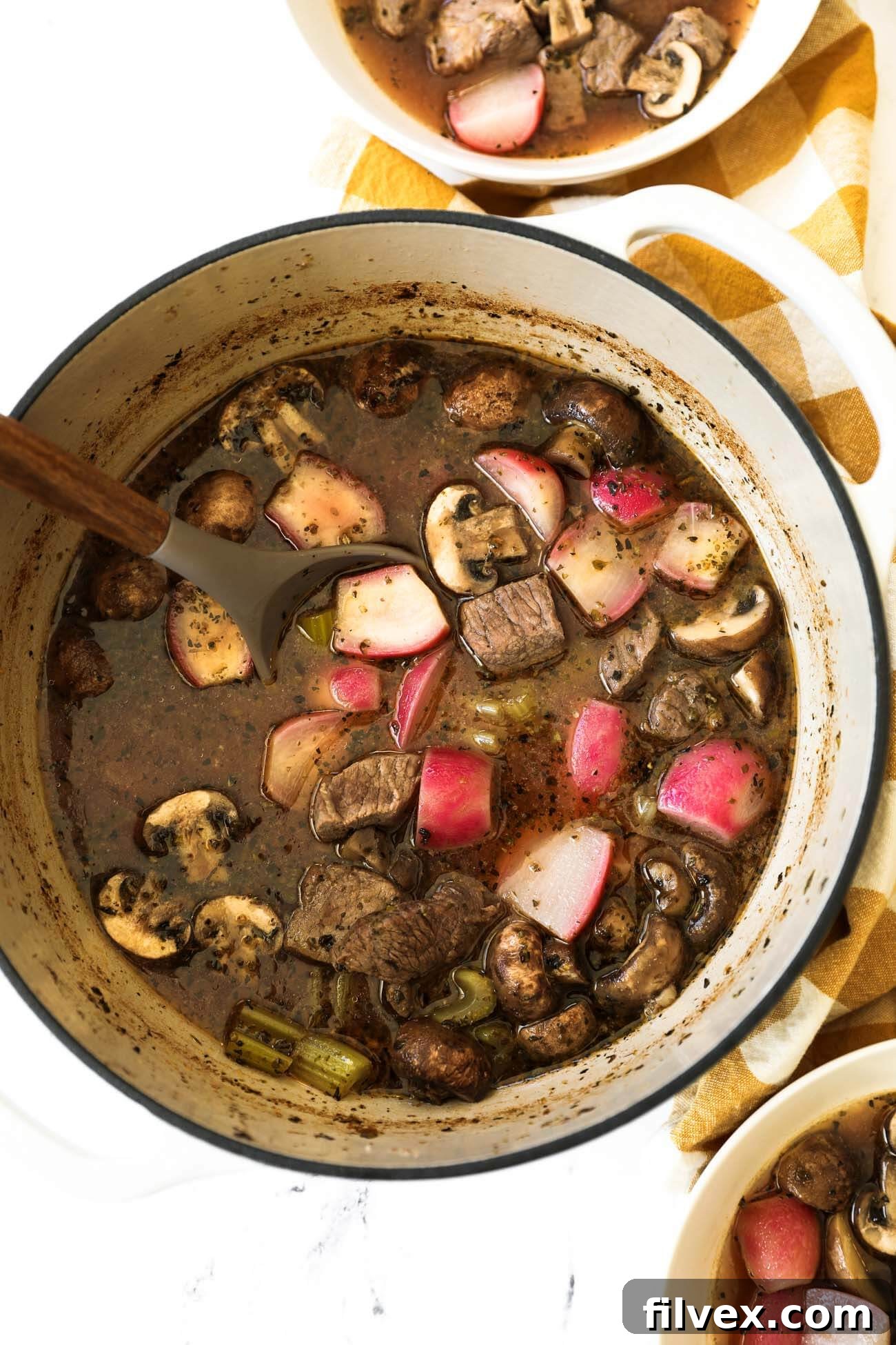 Delicious keto beef stew prepared in an Instant Pot, showing tender beef, radishes, and celery