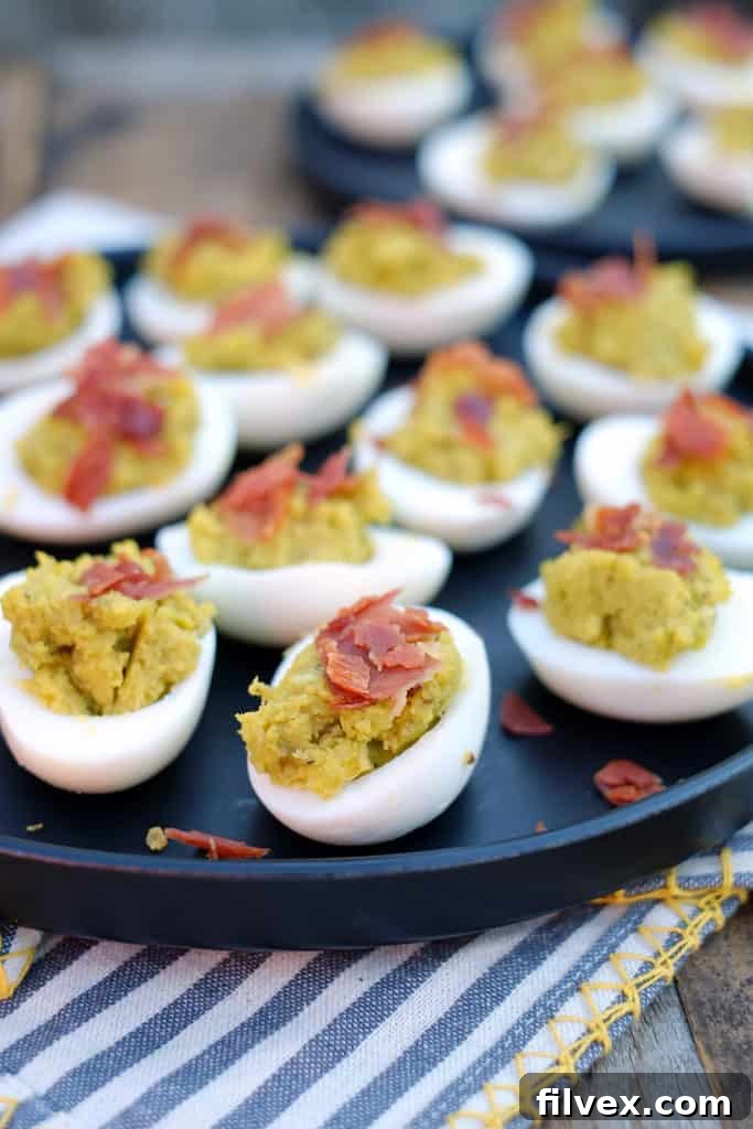 Creamy avocado and crispy prosciutto elevate these Mayo Free Deviled Eggs, making them a perfect Paleo and Gluten-Free appetizer. Easy to prepare and irresistibly delicious.