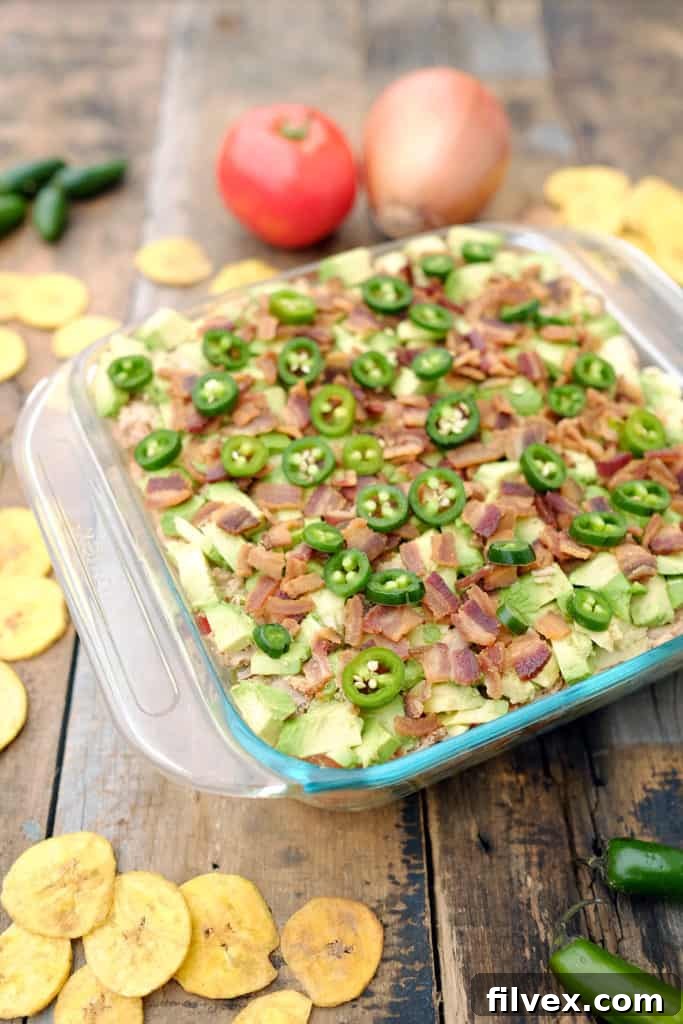 Close-up of a generously layered Paleo and Whole30 seven-layer dip, showcasing the vibrant colors and fresh ingredients. A fantastic dairy-free appetizer.