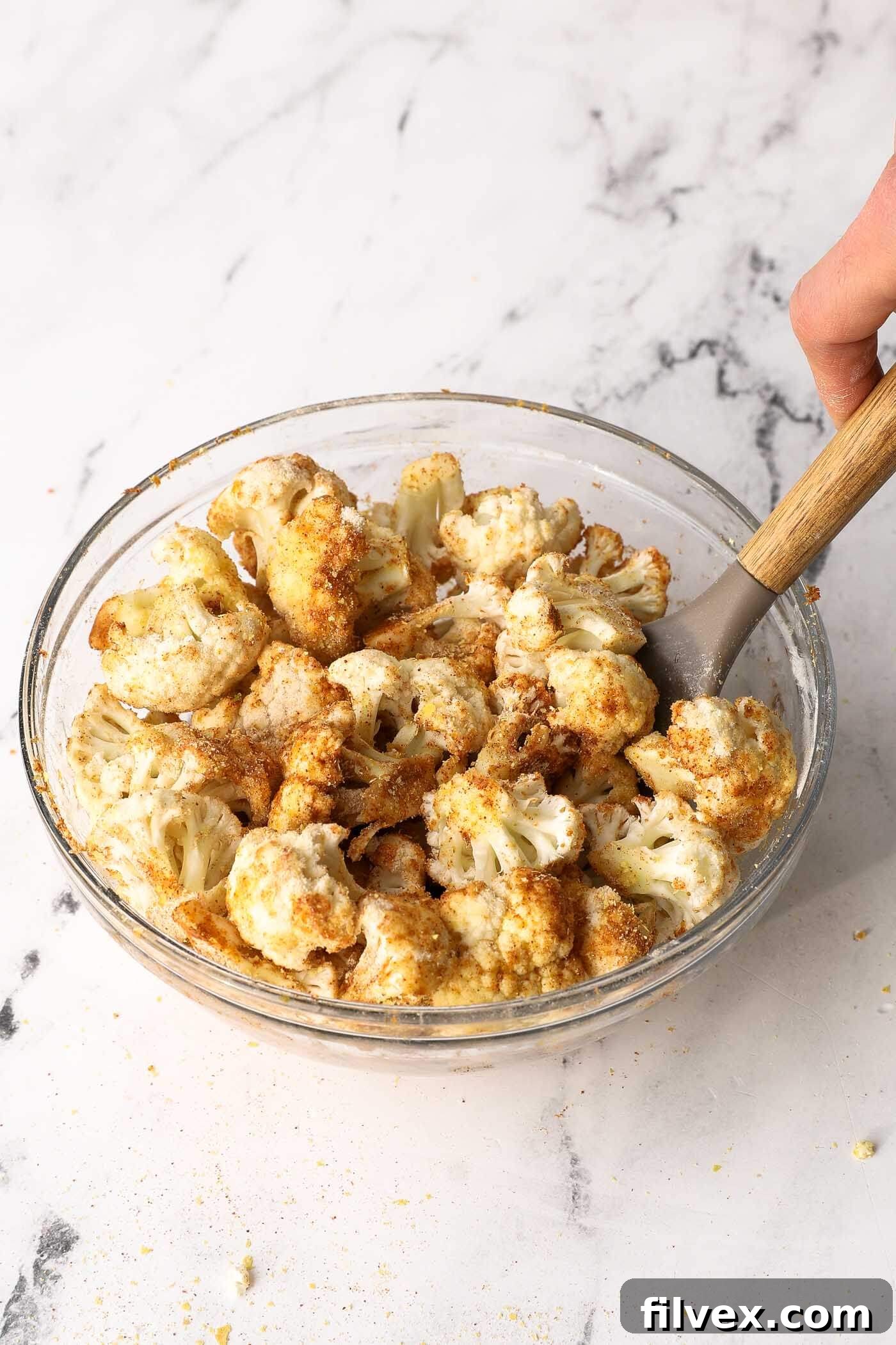 Close-up of cauliflower florets perfectly coated with a golden seasoning blend.