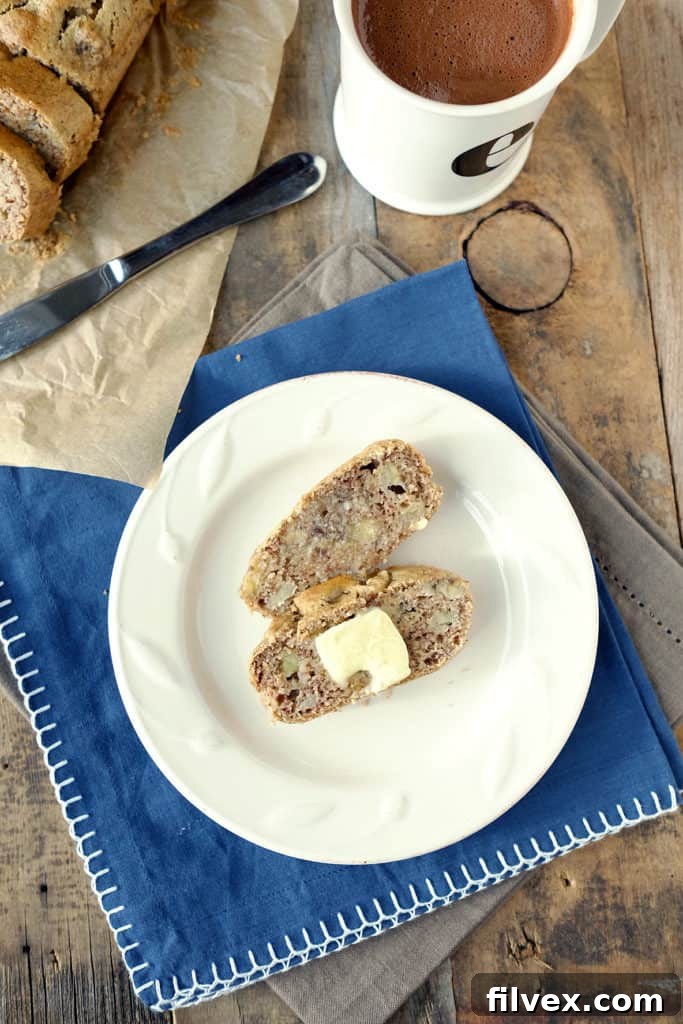 Close-up of a slice of paleo banana bread showing moist texture and banana chunks