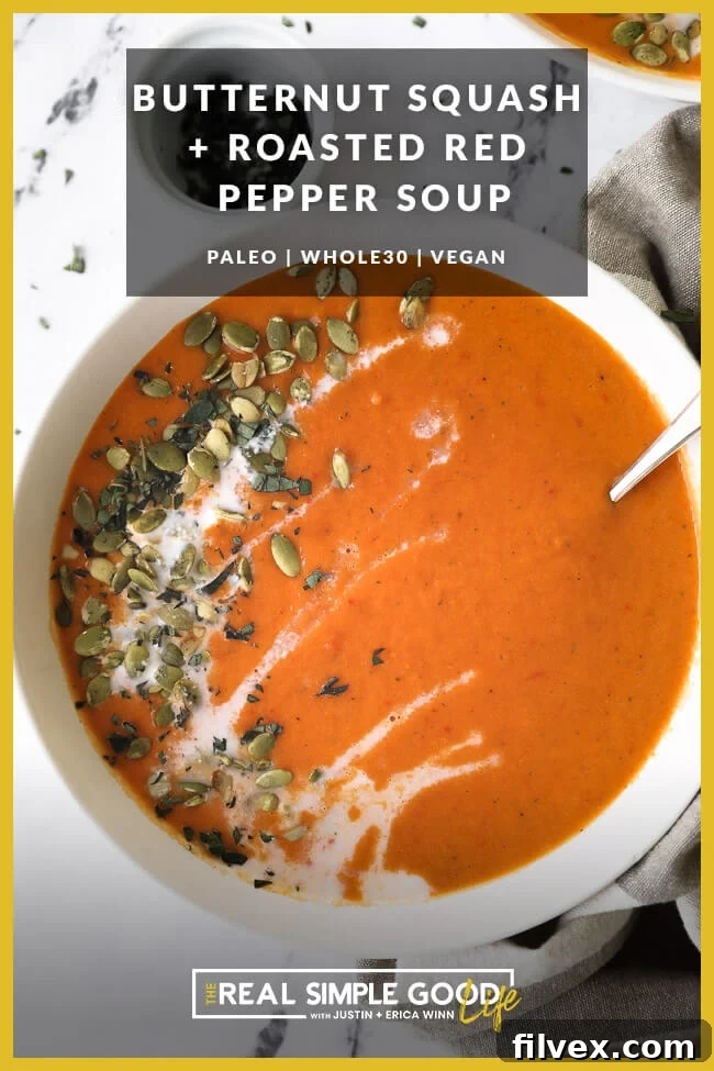 Close up of a bowl of butternut squash and roasted red pepper soup with coconut milk drizzled on top with pumpkin seeds and chopped oregano. Text overlay at top. 