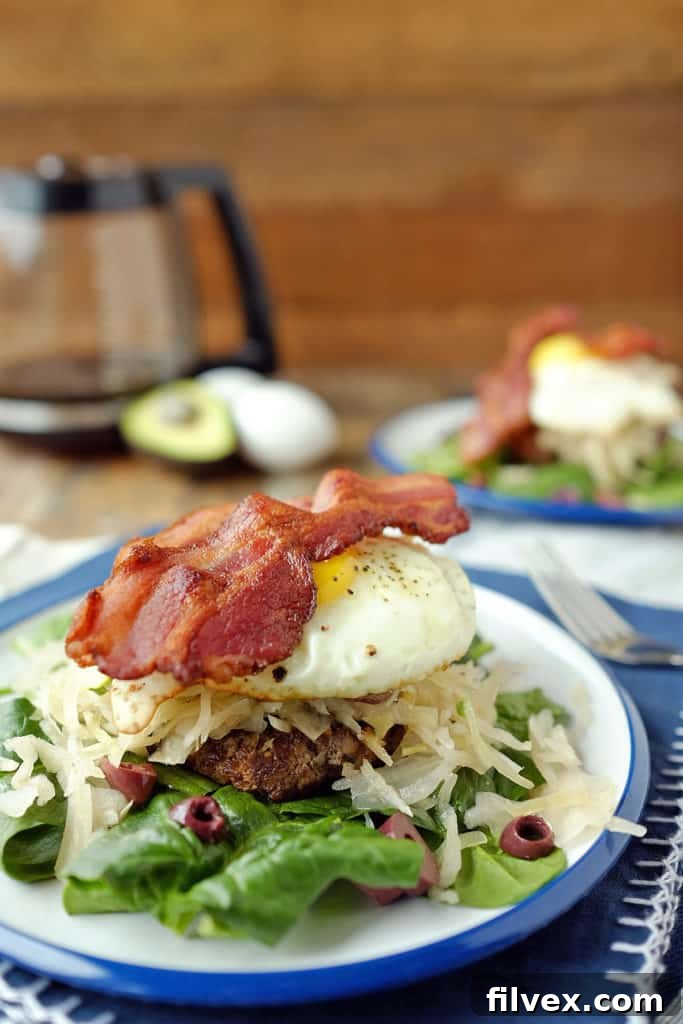 The stacked toppings are the highlight of this Whole30 and Paleo breakfast burger, offering layers of flavor and nutrition. Paleo + Whole30. | realsimplegood.com