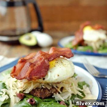 Delicious Paleo Breakfast Burger with stacked toppings.