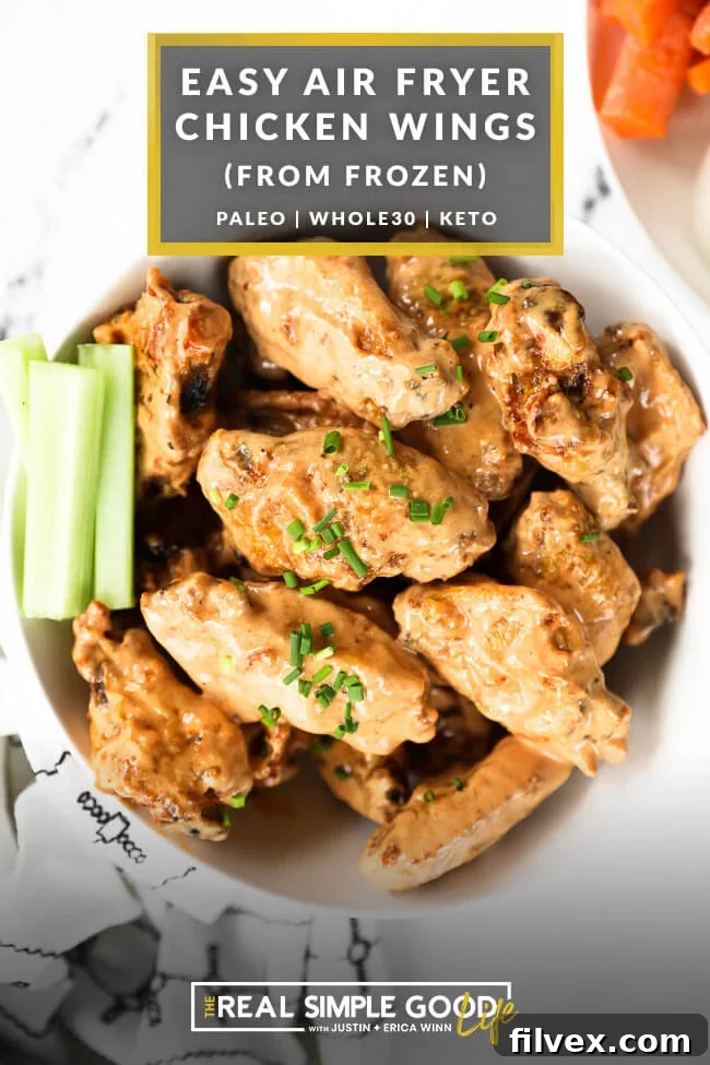 Bowl of chicken wings tossed in creamy buffalo sauce with text overlay on top highlighting the recipe