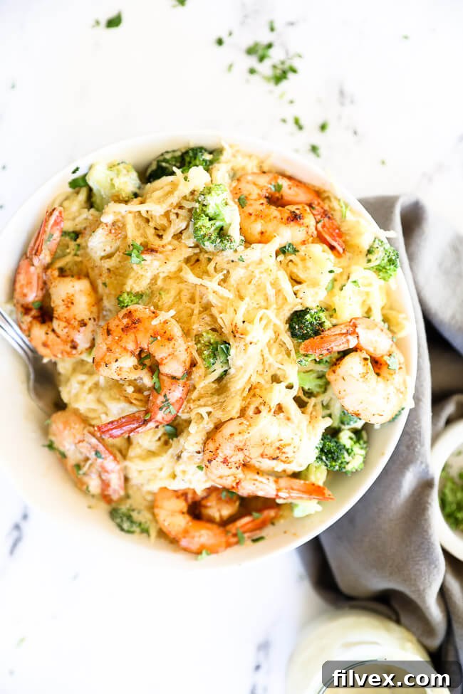 Overhead image of bowl full of shrimp and broccoli spaghetti squash alfredo. 