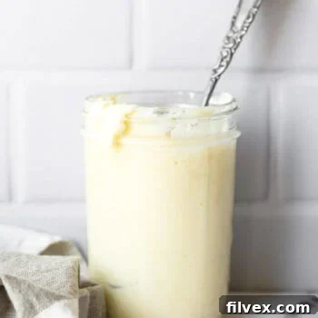 Whole30 and Keto avocado oil mayo in a jar with spoon in the jar