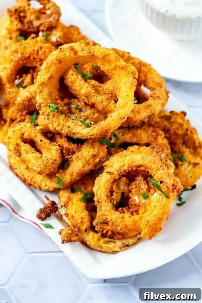 Onion rings on a plate with chopped parsley