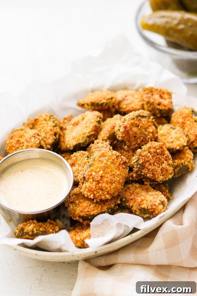 A plate of fried pickles with dipping sauce