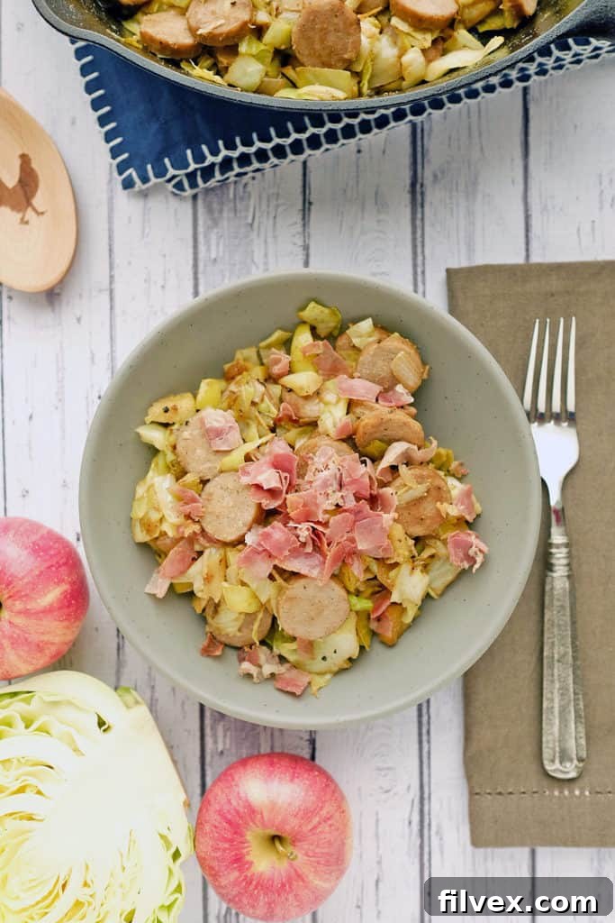 Close-up view of Cabbage and Sausage Side Dish garnished with bacon