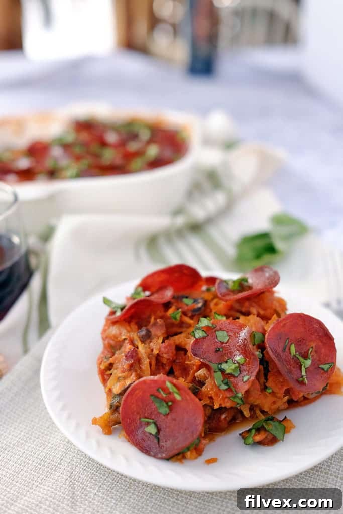 A serving of the healthy Paleo Lasagna, garnished with vibrant fresh basil, artfully presented in a rustic bowl. This image emphasizes the dish's aesthetic appeal and its readiness to be savored as a wholesome and satisfying meal.