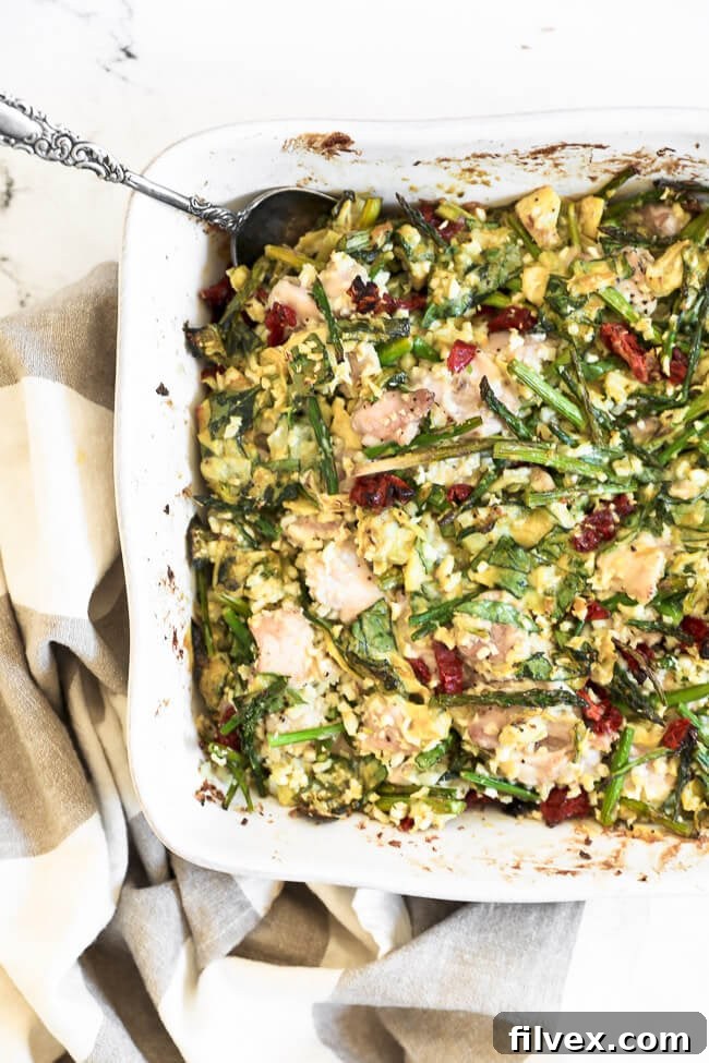 Another overhead view of the creamy spinach artichoke chicken casserole, showcasing the vibrant greens and textures before serving, a perfect image of comfort food.