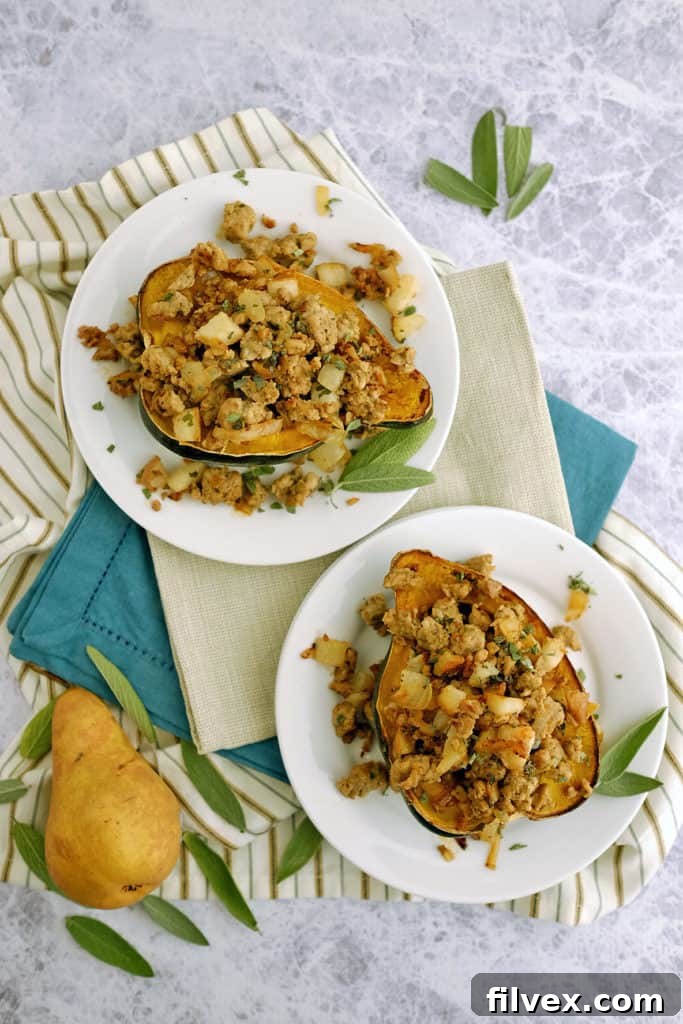 Delicious Pork and Pear Stuffed Acorn Squash on a plate, ready to be enjoyed.