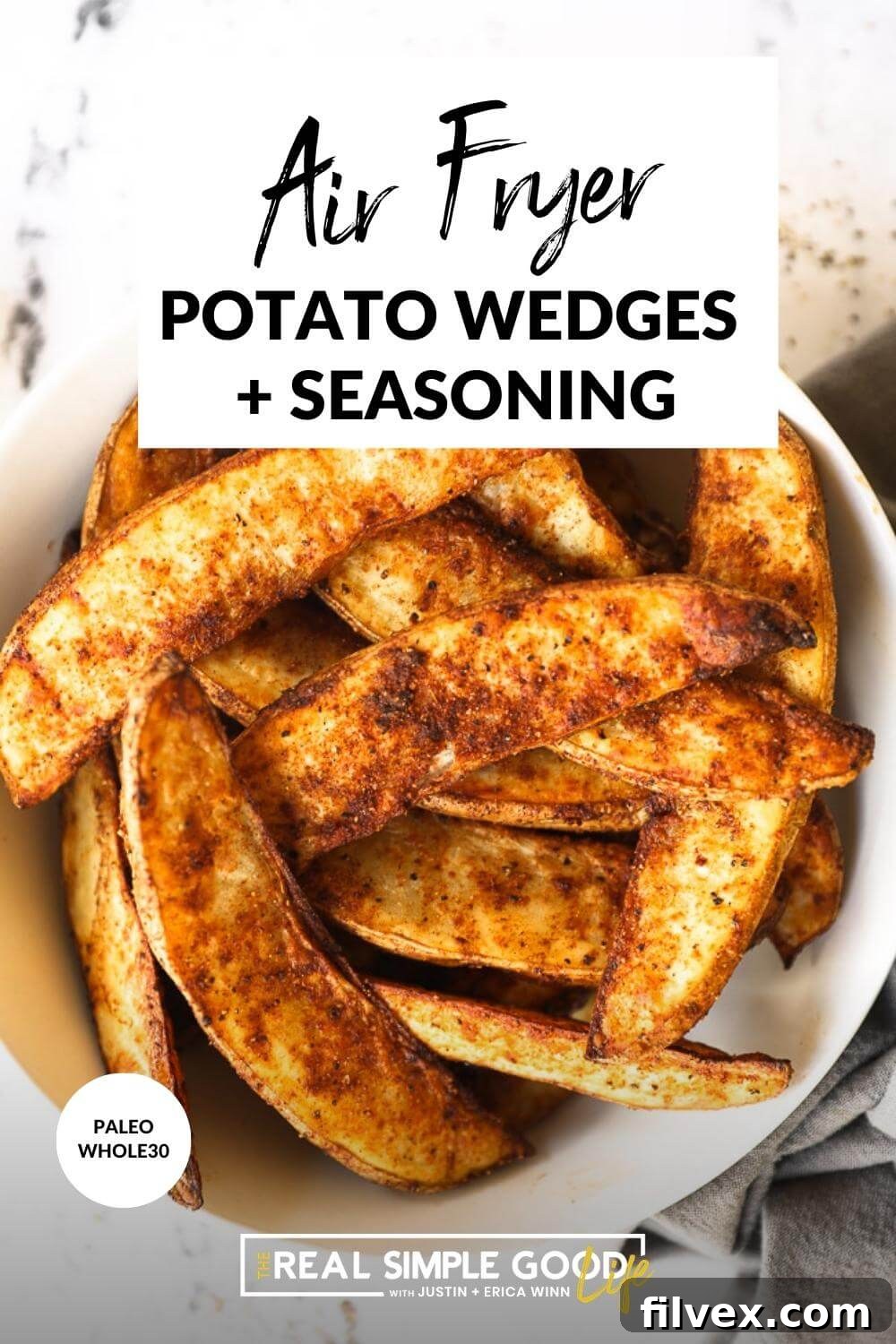 Close up image of air fryer potato wedges in a bowl with text overlay at the top of the image. 