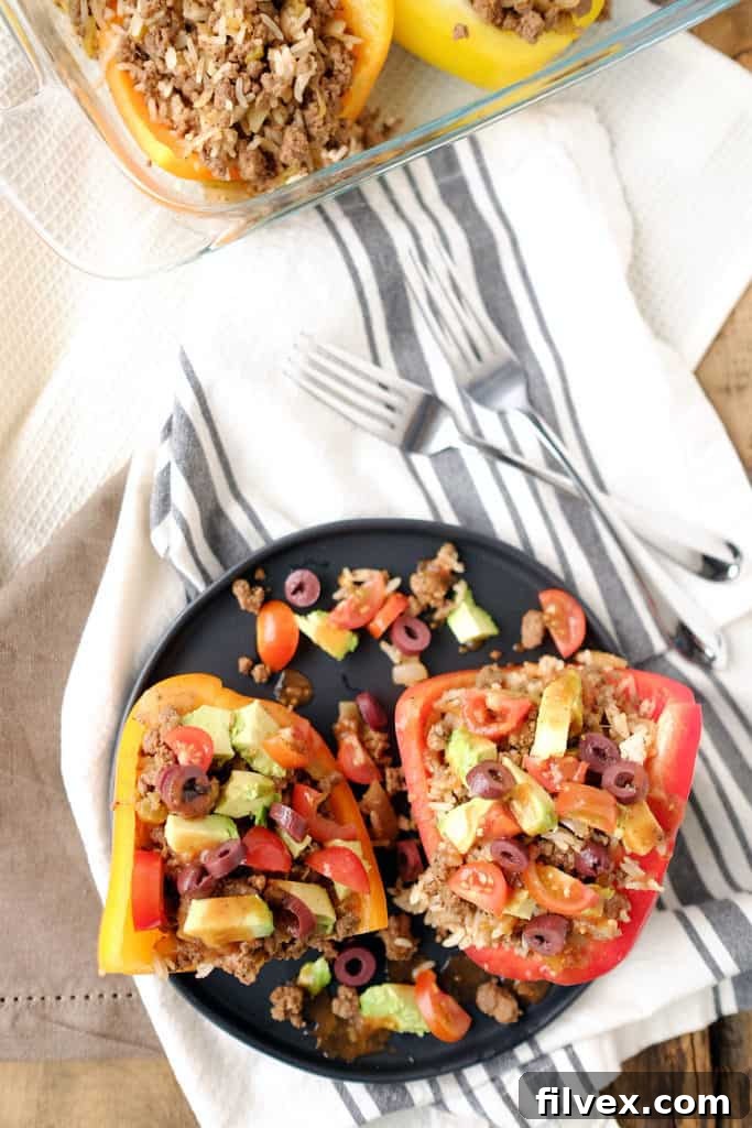 Close-up of baked Taco Stuffed Bell Peppers, showing the rich, savory ground beef filling inside the vibrant red pepper halves.