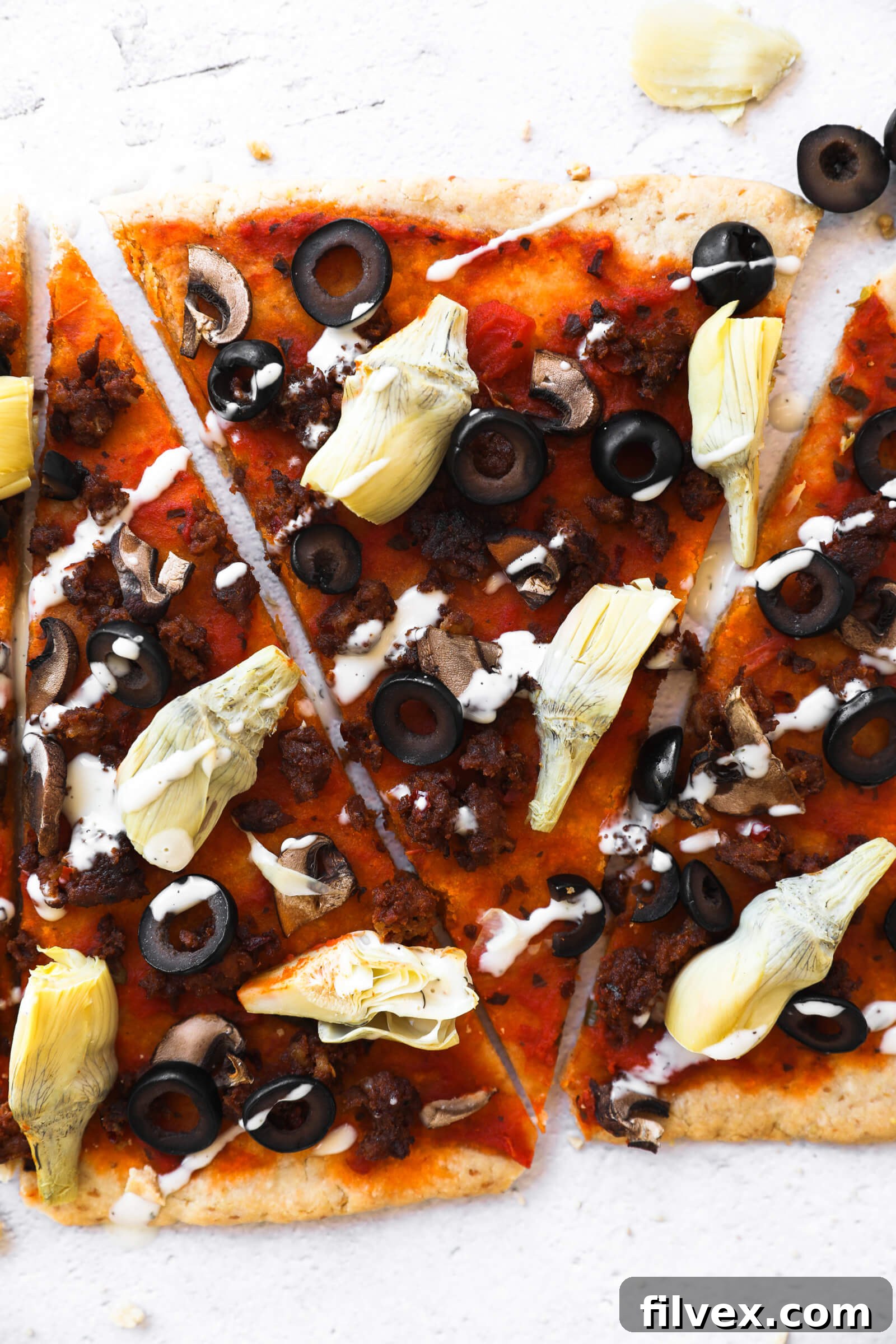 A close-up shot of individual slices of flatbread pizza, ready to be served.