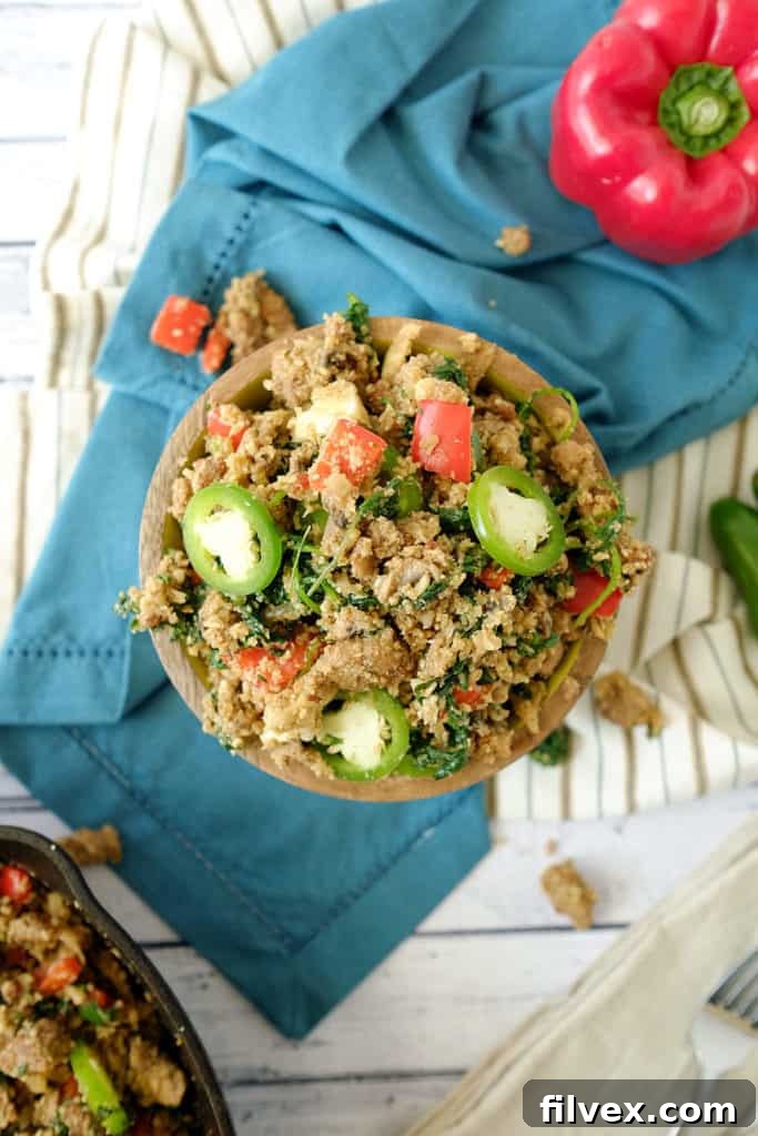 This Paleo + Whole30 version of dirty cauliflower rice is spicy, rich, filling and incredibly tasty. It's not a side dish, it's a whole meal! Italian sausage, jalapeno, bell peppers kale and mushrooms. Paleo + Whole30. | realsimplegood.com