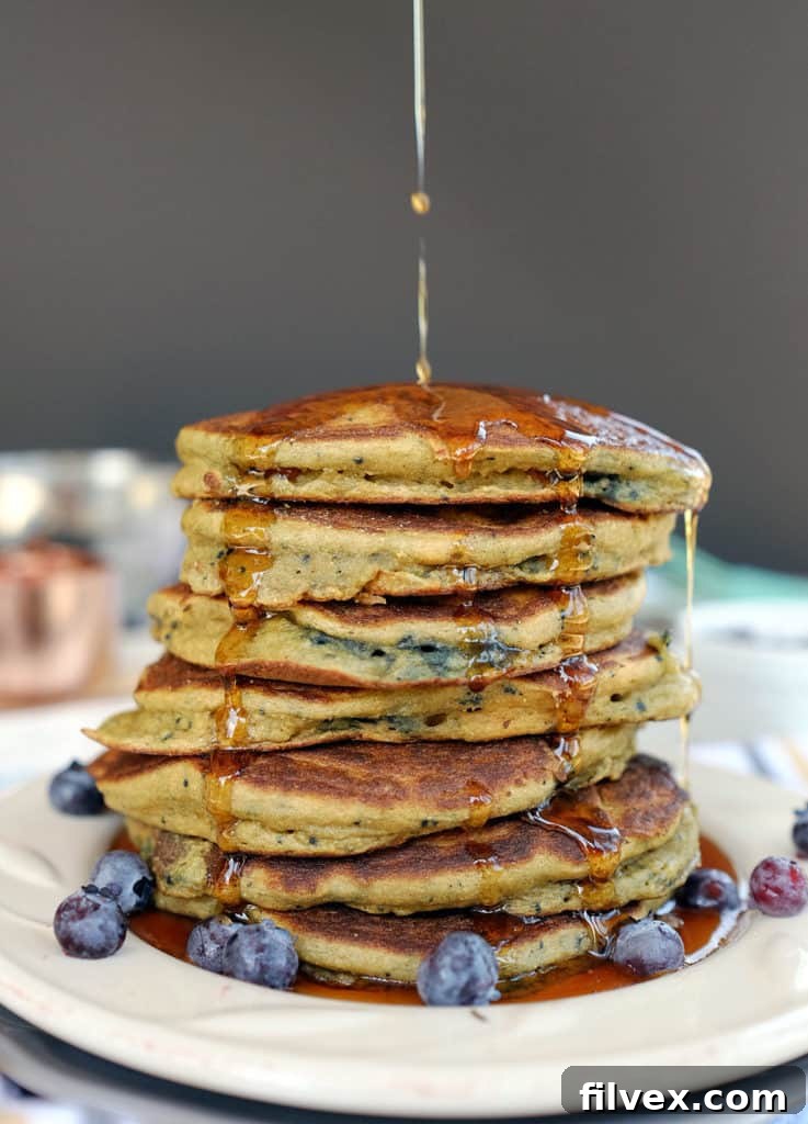 Fluffy Paleo blueberry pancakes stacked high, ready to be served.