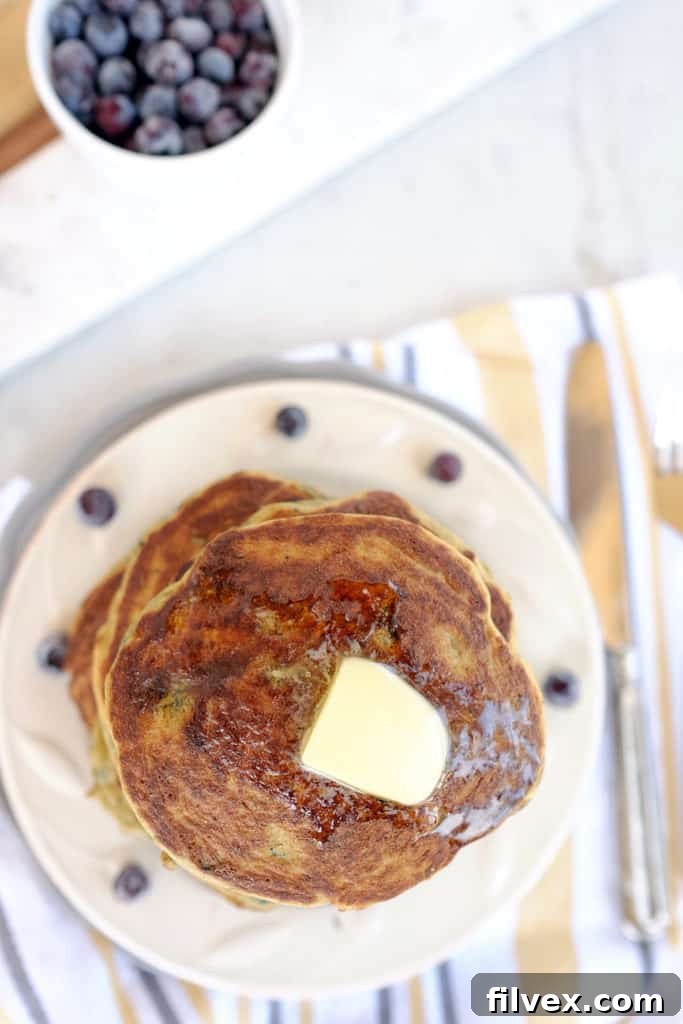 Close-up of fluffy Paleo blueberry pancakes with toppings.