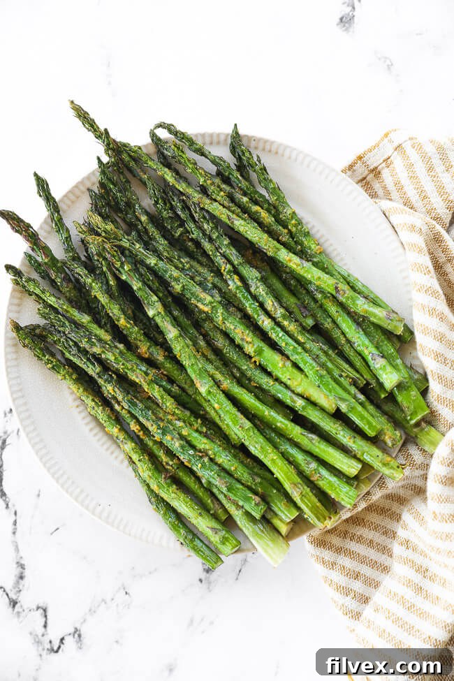 Air fryer asparagus on a plate, ready to be served.