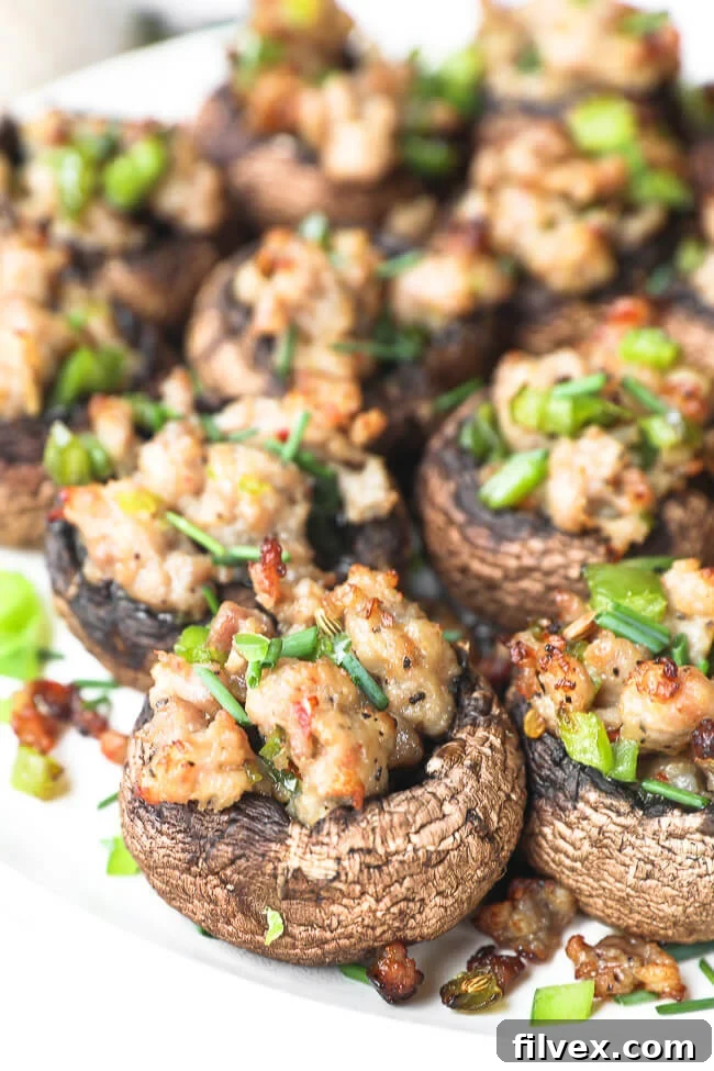 A wider shot of the plate of sausage stuffed mushrooms, showing more of the presentation.