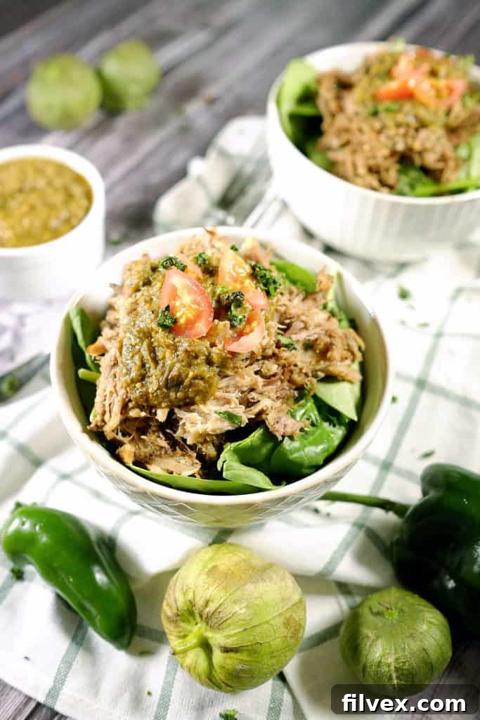 Tomatillos and chilies, garlic and cilantro blend to make the perfect sauce for tender pork in this easy Paleo + Whole30 crockpot pork chile verde recipe. Paleo + Whole30 | realsimplegood.com