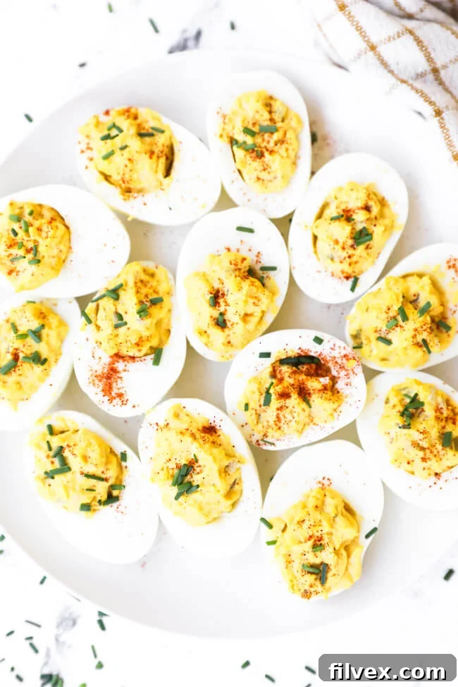 Close-up of perfectly filled keto deviled eggs garnished with paprika, showcasing their creamy texture and inviting appearance, ideal for a low carb appetizer spread.