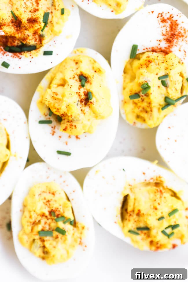 Beautifully arranged deviled eggs on a platter, highlighting their perfect texture and readiness for serving, showcasing make-ahead possibilities.